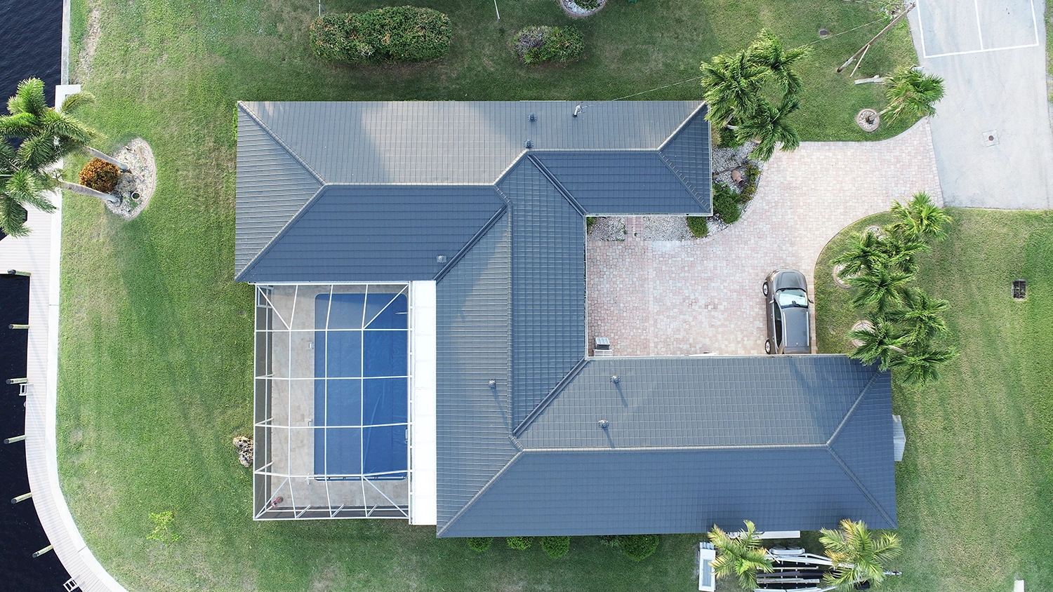 Como Atlantic Grey metal roof — A contemporary waterfront home on Cobalt Court, Cape Coral, Florida.